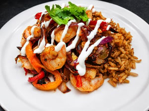 Shrimp with sautéed peppers, onions and seasoned rice