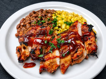 Barbecue chicken with baked beans and corn served at The Lighthouse at Chico